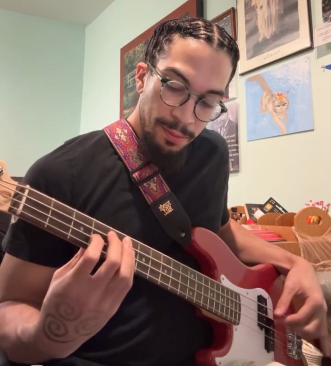 Jonathan Jones-Bey playing a red bass guitar